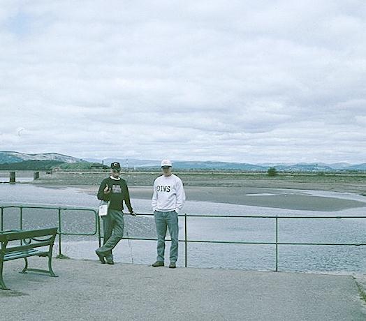 I stand with Gavan, who is wearing his Harvard Din and Tonics sweatshirt, on Arnside Pier at the start of our walk.