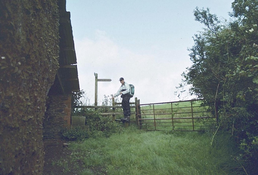 Gavan with stile and fingerpost at a ruin called Wood