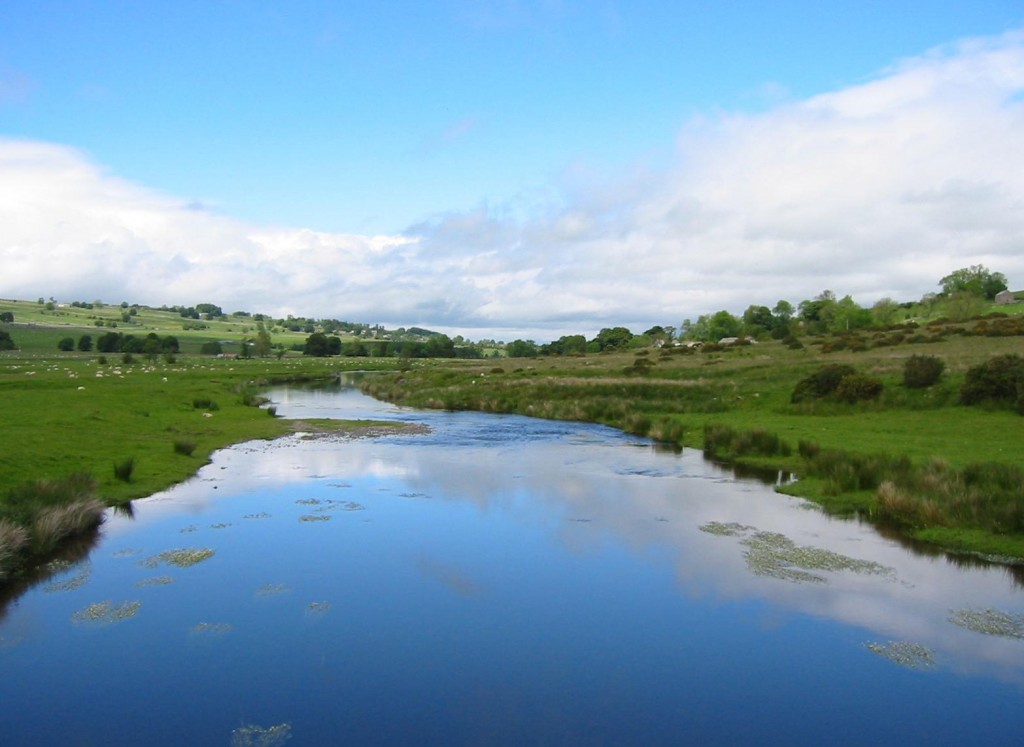 A suspension bridge takes the walker over the River Lowther north of Bampton Grange.