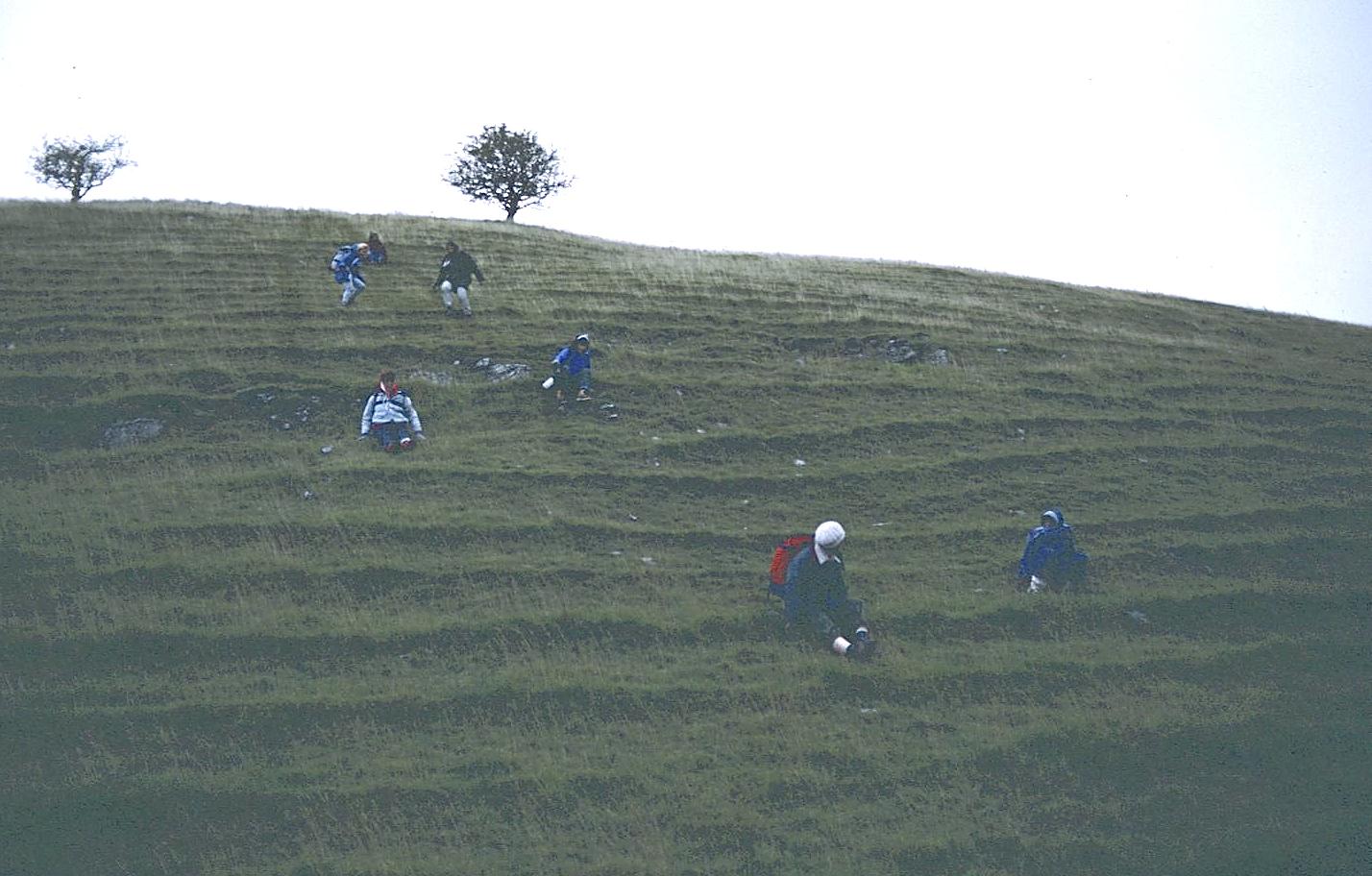 The ladies now find a unique method of descending  into the dry valley that will lead us to the River Dove.