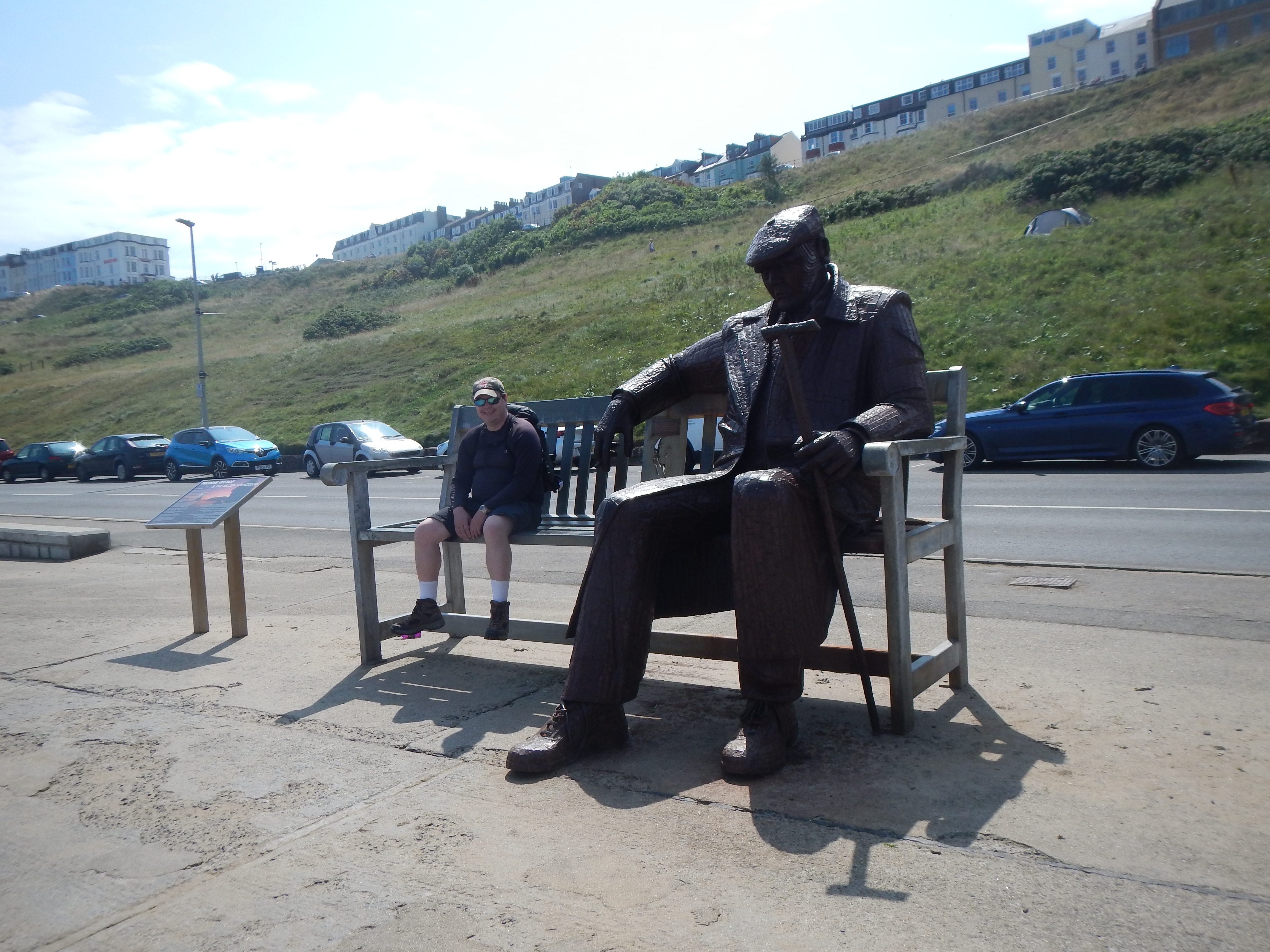 Better than life-size sculpture of Freddie Gilroy facing Scarborough’s Northern Sands.